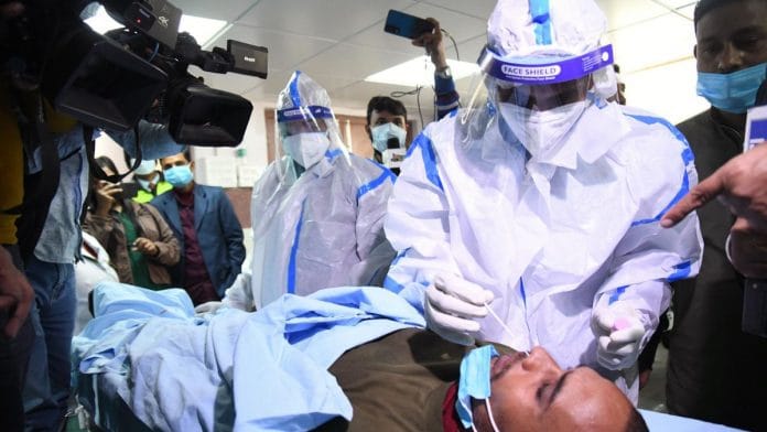 Medics take a nasal swab sample of a man for COVID-19 testing at an isolation ward during a mock drill at Indira Gandhi Institute of Medical Sciences (IGIMS), in Patna on Tuesday | ANI