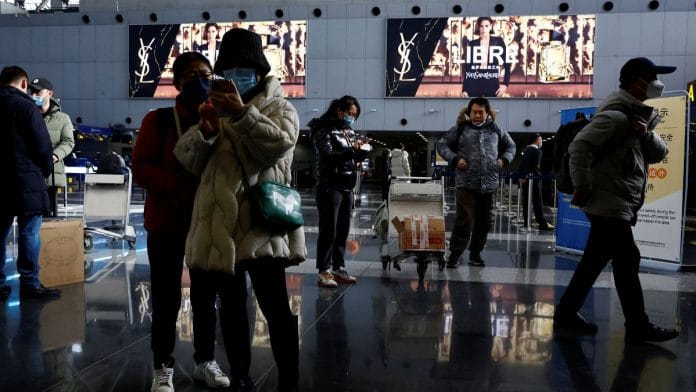 File photo of travellers stand by their luggage at Beijing Capital International Airport, amid the coronavirus disease (Covid-19) outbreak in Beijing, China | Reuters/Tingshu Wang