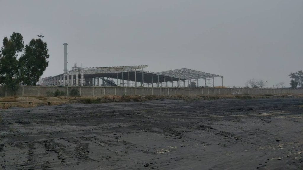A plot adjacent to the alcohol unit, the brown top soil, covered by mushy black substance