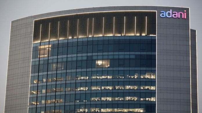 File photo of the logo of the Adani Group is seen on the facade of one of its buildings on the outskirts of Ahmedabad, India, 13 April 2021 | Reuters/Amit Dave