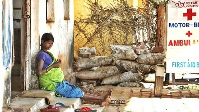 A pregnant women sits outside an early referral centre in Orchha village | Praveen Jain | ThePrint