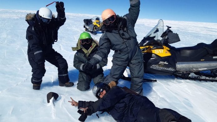 The researchers with the 7 kg meteorite in Antartica | Photo credit: phys.org