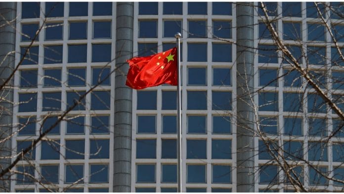 File photo of a Chinese flag fluttering outside the Chinese foreign ministry in Beijing, China on 24 February, 2022 | Reuters