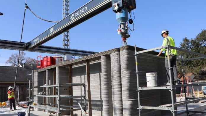 A 12-ton industrial 3-D printer is used to print concrete for the first 3-D-printed, two-story home currently under construction in Houston, Texas, US on 3 January, 2023 | Reuters