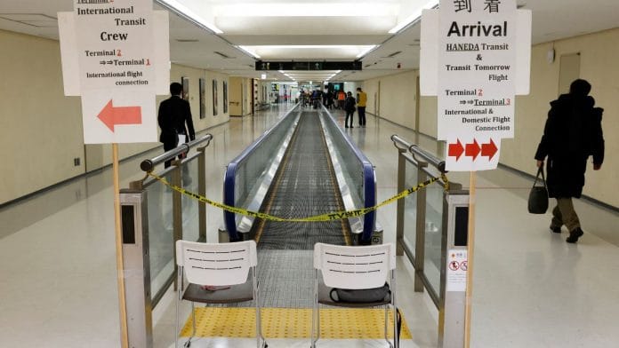A passenger of a plane from Dalian in China, heads to the Covid test area, upon his arrival at Narita international airport in Narita, east of Tokyo, Japan on 12, 2023 | Reuters