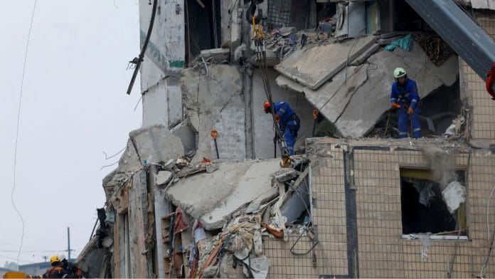 Emergency personnel work at the site where an apartment block was heavily damaged by a Russian missile strike, amid Russia's attack on Ukraine, in Dnipro, Ukraine 16 January, 2023 | Reuters