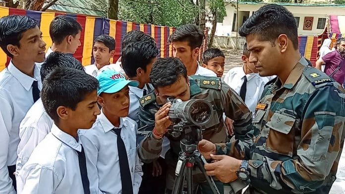 Army personnel set a monocular for the students during an arms exhibition organised by the Indian Army, at Ajot village in Poonch | ANI file photo