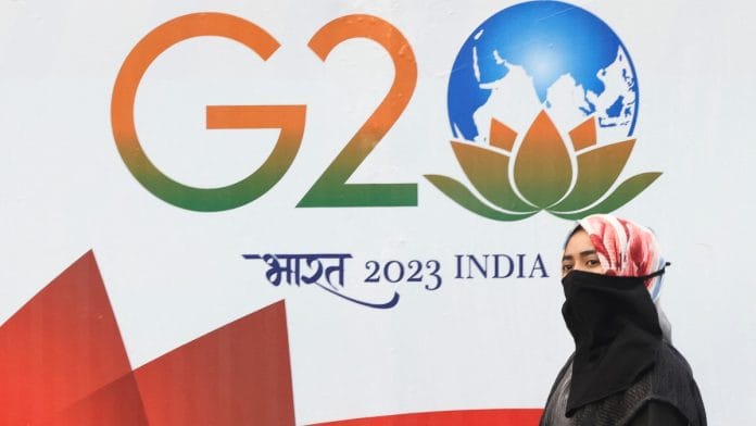 A woman walks past a hoarding of India's G20 presidency, on a street in Mumbai | Reuters file photo A woman walks past a hoarding of India's G20 presidency, on a street in Mumbai | Reuters file photo