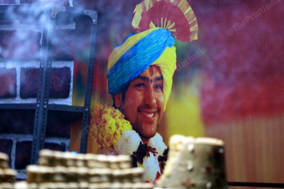 Baba Bagheshwar's poster in one of the sweet shops near the temple | Photo: Praveen Jain | ThePrint