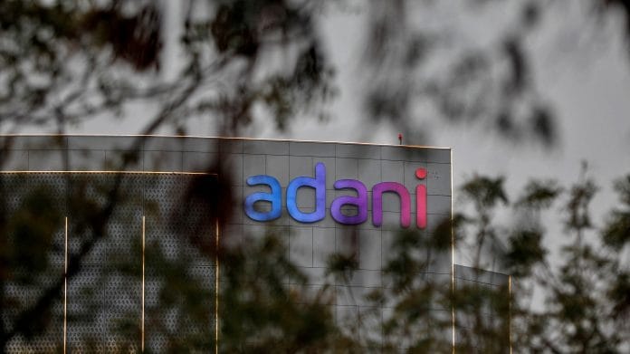 The logo of the Adani Group is seen on the facade of its Corporate House on the outskirts of Ahmedabad on 27 January 2023 | Photo: Reuters