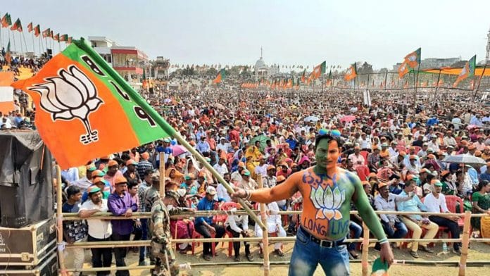 A BJP supporter waves the party flag at a rally | Representational image | ANI A BJP supporter waves the party flag at a rally | Representational image | ANI