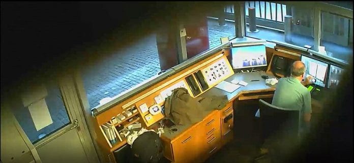 David Ballantyne Smith takes video of CCTV monitors at the security kiosk of the British Embassy in Berlin, Germany, August 3, 2020, in this still image taken from a video played in court at the Old Bailey, in London, Britain, on 13 February, 2023