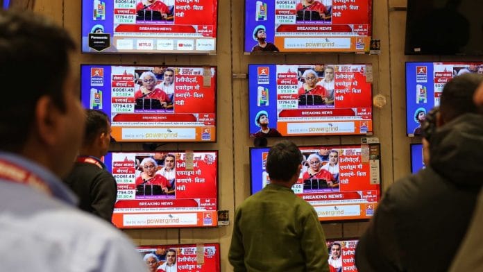 People watch the television as Finance Minister Nirmala Sitharaman presents her Union Budget 2023 speech in parliament, on 1 February 2023 | Suraj Singh Bisht | ThePrint