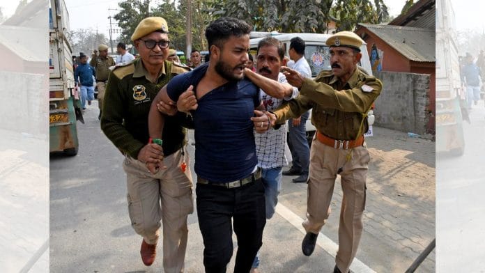 Police personnel restrain a relative of a person arrested in the involvement of child marriage in Morigaon, Assam | ANI: Photo
