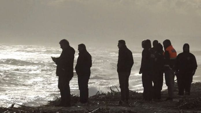 Rescuers work at the beach where bodies of refugees were found after a shipwreck, in Cutro, the eastern coast of Italy's Calabria region on 26 February, 2023, in this screen grab taken from a Reuters TV video
