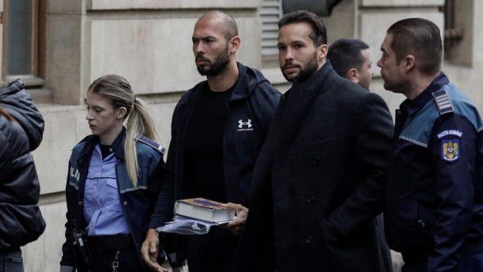 Andrew Tate and his brother Tristan are escorted by police officers outside the headquarters of the Bucharest Court of Appeal, in Bucharest, Romania, 10 January, 2023 | Reuters