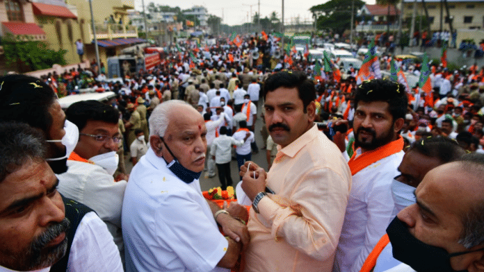 File photo of BJP senior leader B.S.Yediyurappa with his son B.Y. Vijayendra at a poll rally in Karnataka | Twitter | @BYVijayendra