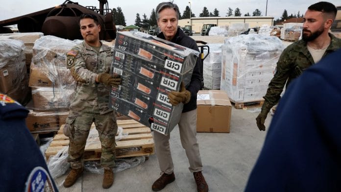 US Secretary of State Antony Blinken helps US military personnel carry aid, at Incirlik Air Base near Adana, Turkey on Sunday | Reuters