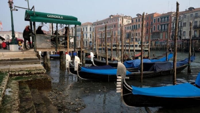 Gondolas are pictured in the Grand Canal during a severe low tide in the lagoon city of Venice, Italy| REUTERS/Manuel Silvestri