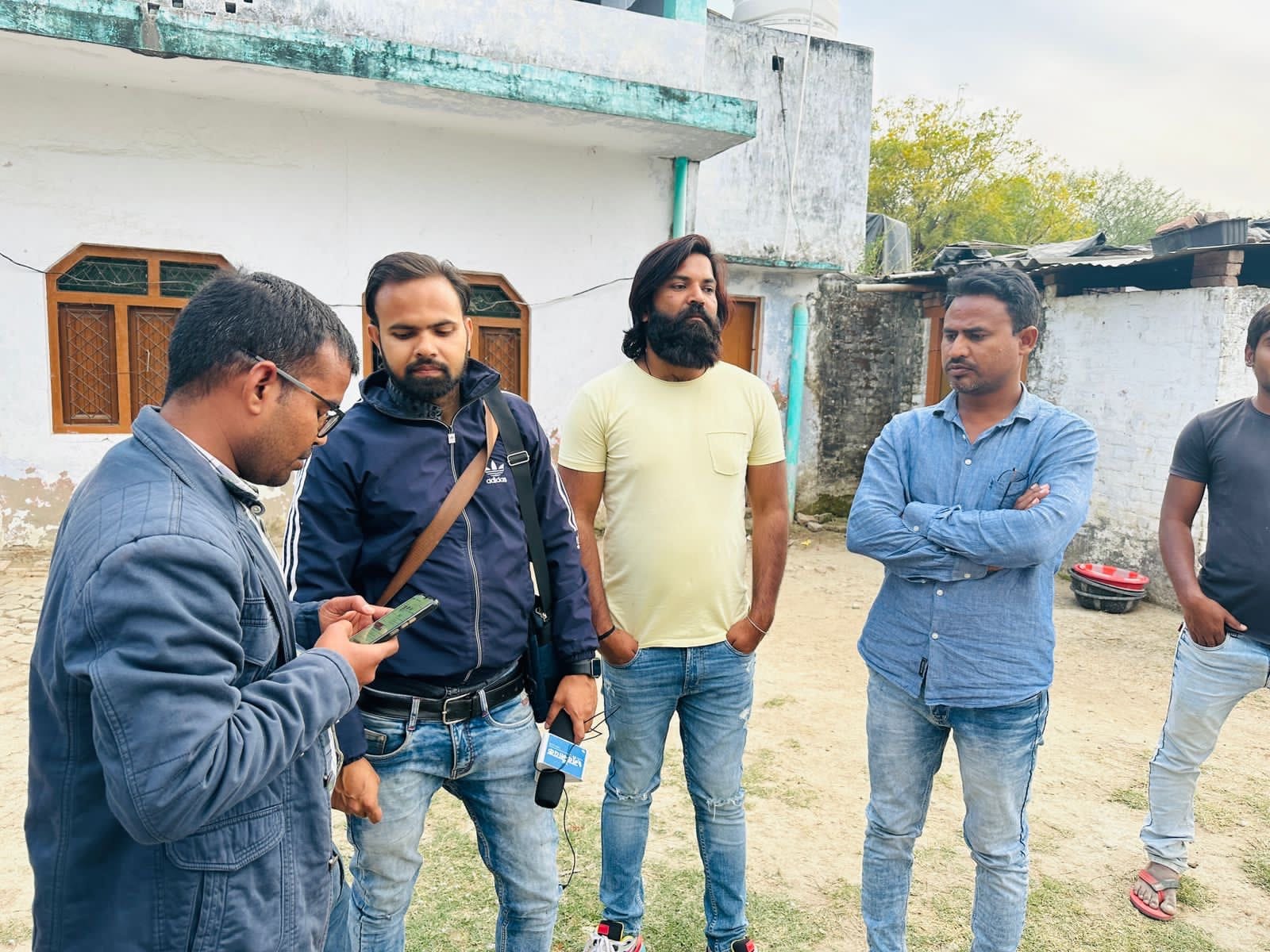 Arif in Mandhka with journalists and fellow villagers | special arrangement