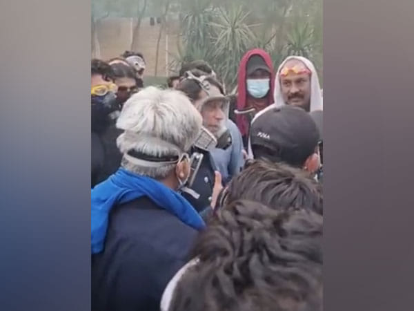 Imran Khan interacts with PTI supporters in gas mask after security forces withdraw from Zaman Park