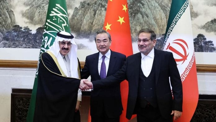 China's top diplomat Wang Yi with Ali Shamkhani, Iran’s Supreme National Security Council secretary, and Minister of State & national security adviser of Saudi Arabia Musaad bin Mohammed Al Aiban pose for pictures during a meeting in Beijing, on 10 March 2023 | China Daily via Reuters