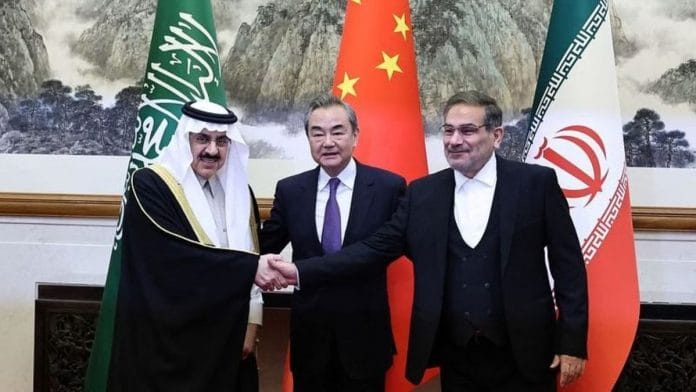 China's top diplomat Wang Yi with Ali Shamkhani, Iran’s Supreme National Security Council secretary, and Minister of State & national security adviser of Saudi Arabia Musaad bin Mohammed Al Aiban pose for pictures during a meeting in Beijing, on 10 March 2023 | China Daily via Reuters