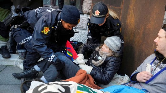Greta Thunberg is carried away by police officers as activits demonstrate outside the Ministry of Finance entrance and several other ministries in protest against the Fosen wind turbines not being demolished, which was built on land traditionally used by indigenous Sami reindeer herders, in Oslo, Norway, March 1, 2023. Alf Simensen/NTB/via REUTERS