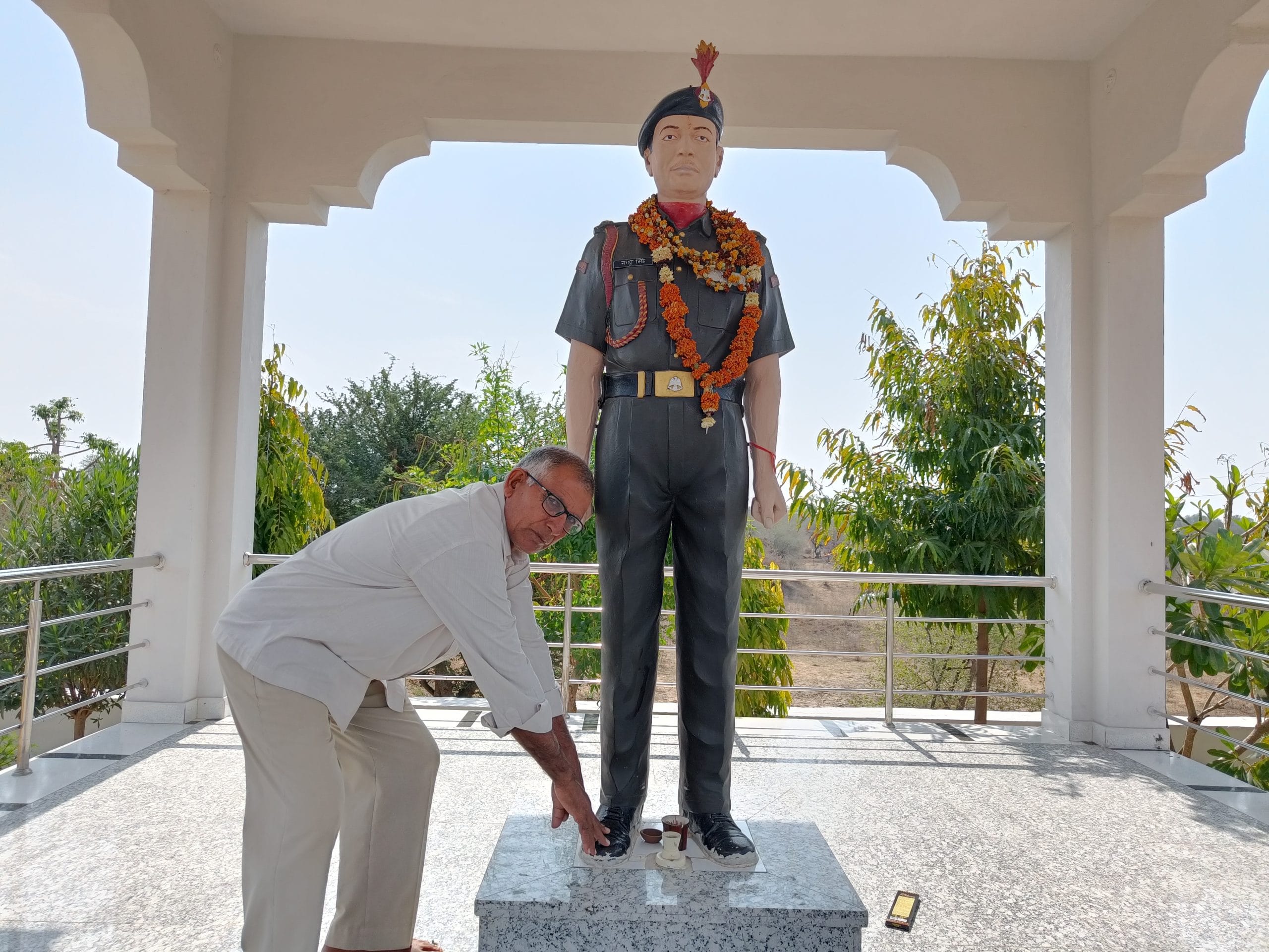 Subedar Nathu Singh's brother Hetram touching his feet | Photo: Krishan Murari/The Print