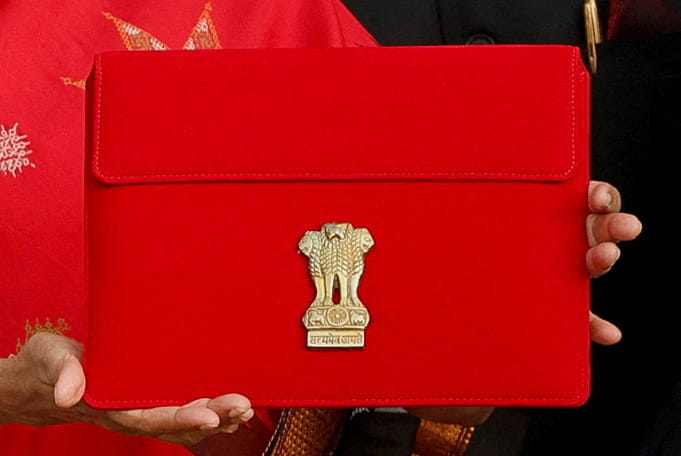 Finance Minister Nirmala Sitharaman holds up a folder with the Government of India’s logo as she leaves her office to present the federal budget in the parliament, in New Delhi on 1 February 2023 | Photo: Reuters