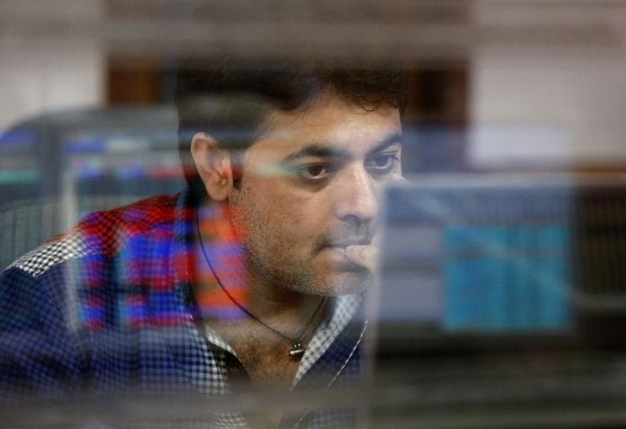 A broker reacts while trading at his computer terminal at a stock brokerage firm in Mumbai, India, 26 February, 2016 | Reuters/Shailesh Andrade