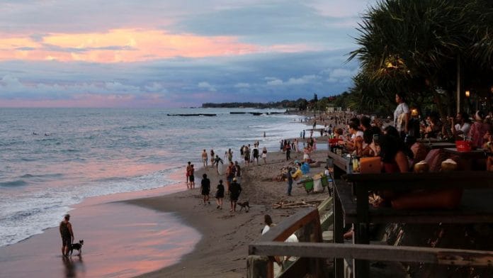 Tourists enjoy the sunset at Canggu beach amidst the coronavirus disease (Covid-19) pandemic in Bali, Indonesia | File Photo: Reuters
