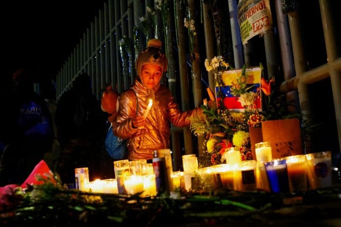 Fatima Pavon, 12, a migrant girl from Venezuela take part in a vigil outside the office of the National Institute of Migration (INM) in memory of the victims of a fire that broke out late on Monday at a migrant detention center, in Ciudad Juarez, Mexico, March 28, 2023. REUTERS/Jose Luis Gonzalez