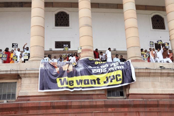 Opposition MPs stage a protest on the first floor of Parliament demanding a JPC probe into the Adani row, in New Delhi on Tuesday | ANI