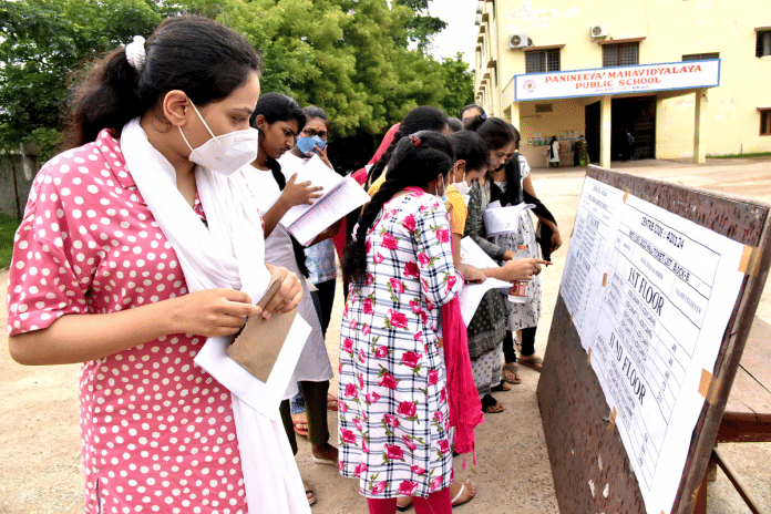 File photo of candidates checking roll numbers before they appear for NEET UG 2022 at an examination centre in Hyderabad | ANI