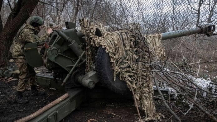 A Ukrainian service member prepares to shoot from a howitzer at a front line, as Russia's attack on Ukraine continues, near the city of Bakhmut, Donetsk region, Ukraine 2 March, 2023 | Reuters