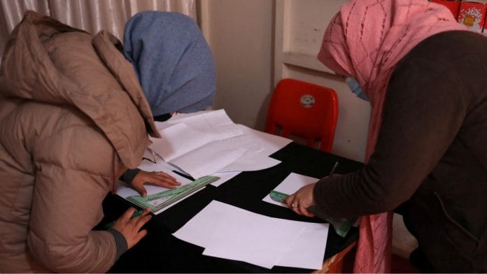 File photo of Afghan women draw sewing patterns on paper at a sewing workshop in Kabul, Afghanistan 15 January, 2022 | Reuters
