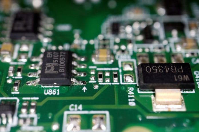 File photo of semiconductor chips seen on a printed circuit board in this illustration picture taken 17 February, 2023 | Reuters