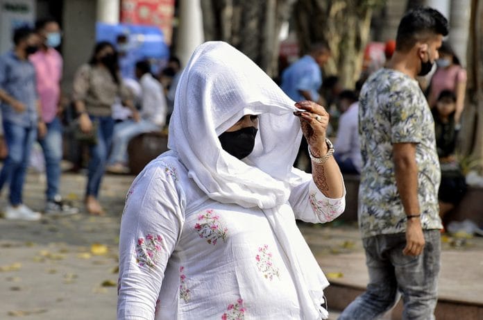 A woman in mask at Connaught Place, in New Delhi | Photo: ANI