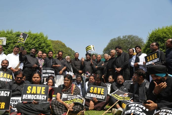 Congress chief Mallikarjun Kharge along with opposition MPs in black attire protests at Vijay Chowk in New Delhi on 27 March 2023 | Photo: Suraj Singh Bisht | ThePrint