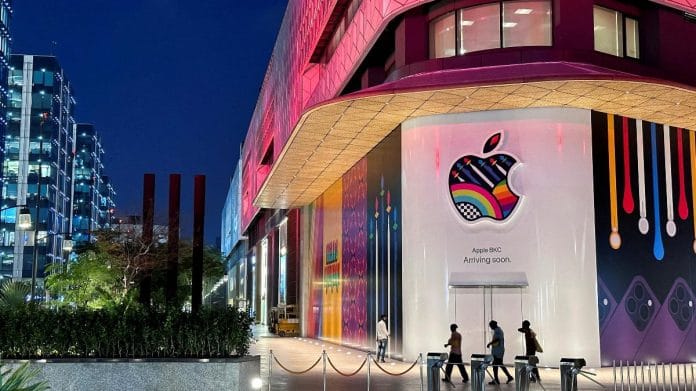 People walk past the barricade of India's first Apple retail store at at Jio World Drive Mall, Mumbai | Reuters