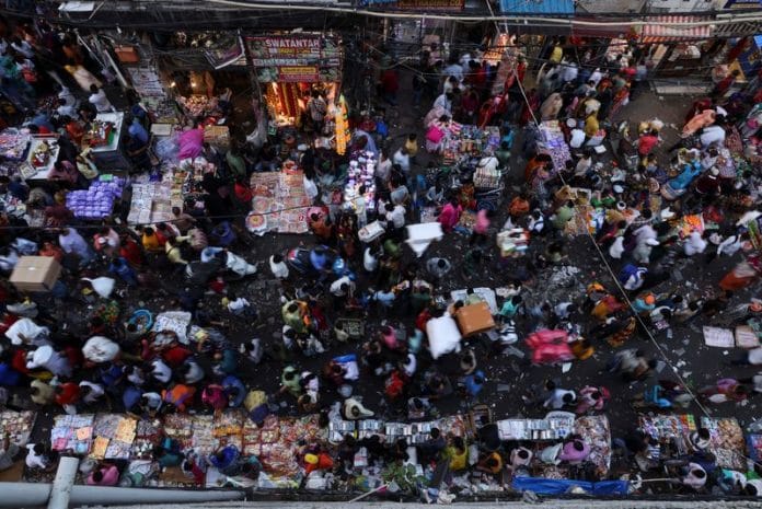 People shop at a crowded market in the old quarters of Delhi | Reuters