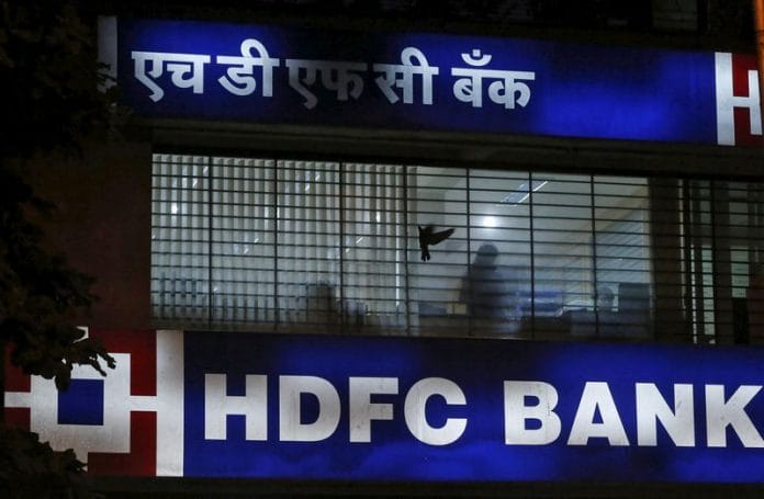 A bird flies past a window of a HDFC Bank branch office in Mumbai | Reuters file photo