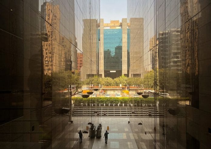 A man walks between the buildings at a commercial centre in New Delhi | Reuters file photo