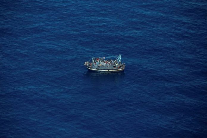 A boat in distress with about 400 people on board is pictured in the Central Mediterranean Sea | Giacomo Zorzi/ Sea-Watch/Handout via Reuters
