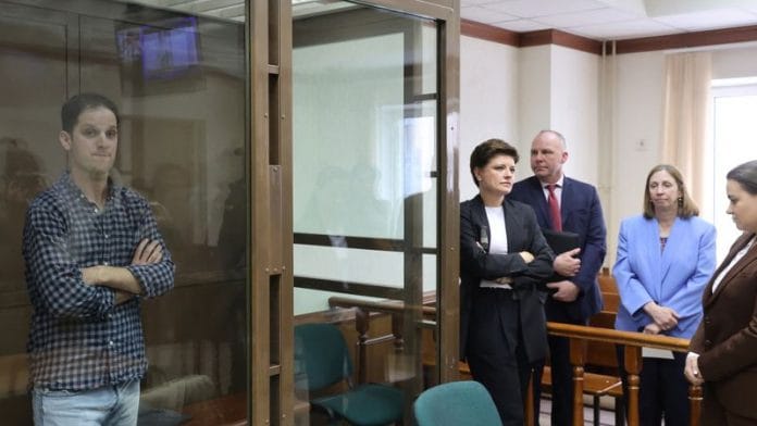 Wall Street Journal reporter Evan Gershkovich stands behind a glass wall of an enclosure for defendants before a hearing to consider an appeal against his detention, in Moscow, Russia on 18 April, 2023 | Reuters
