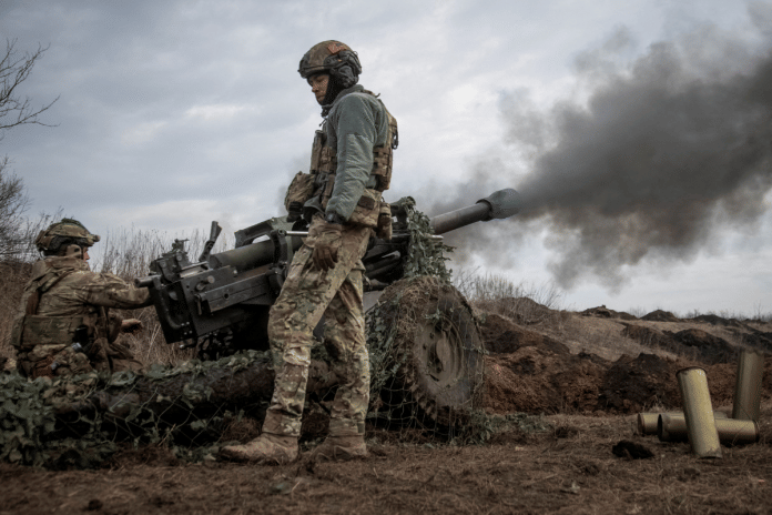 File photo of Ukrainian service members firing a howitzer at a front line near the city of Bakhmut | Reuters