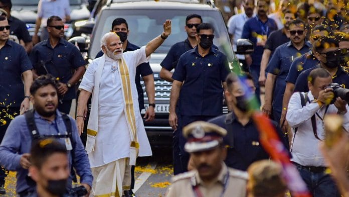 Prime Minister Narendra Modi waves at supporters during a roadshow, in Kochi, on 24 April 2023 | Photo: PTI