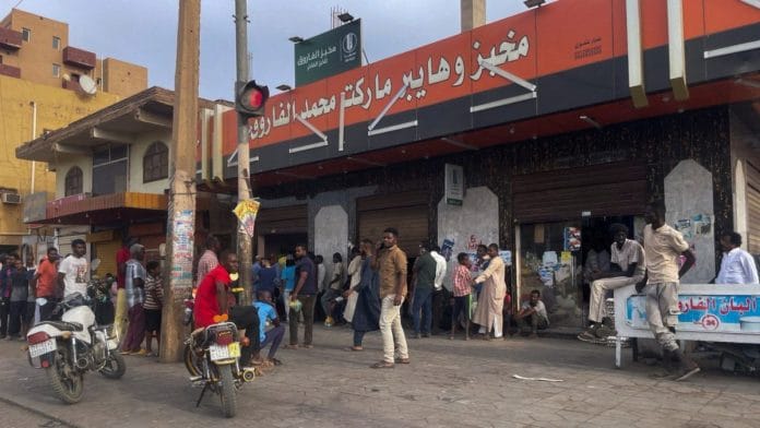 People gather to get bread during clashes between the paramilitary Rapid Support Forces and the army in Khartoum, Sudan, on 18 April 2023 | Reuters