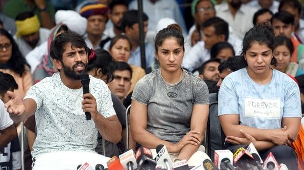 Indian wrestlers Bajrang Punia, Vinesh Phogat and Sakshi Malik address the media at Jantar Mantar, New Delhi | File Photo: ANI